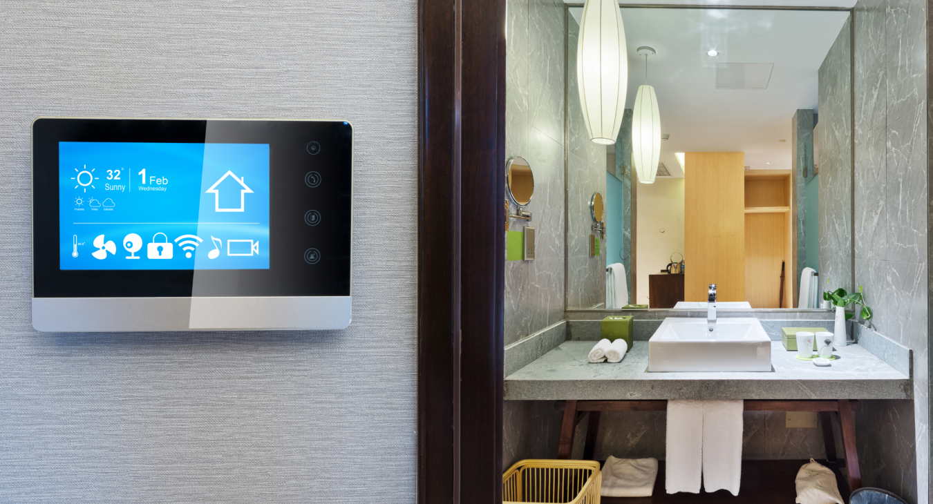Bathroom with smart thermostat on wall